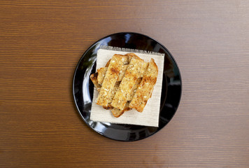 Homemade garlic bread on wood background