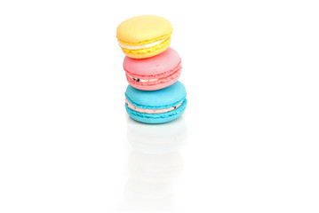 Stacked pastel color macaroons on white background with selectiv