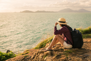traveler asia woman sitting on sea cliff