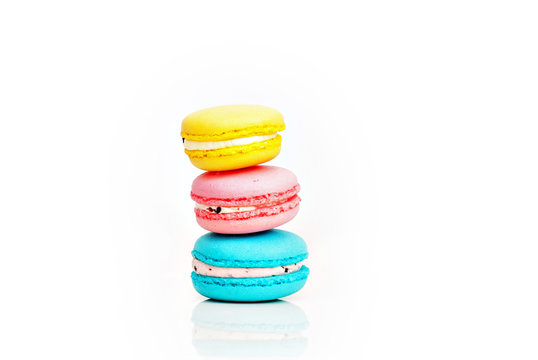 Stacked pastel color macaroons on white background with selectiv