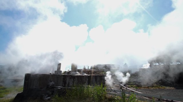 Hot water flowing out of pipe, hot spring water boiling, Beppu, Japan
