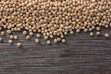 Soybeans on old wooden background.
