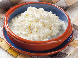 Fresh Cottage cheese on a wooden table