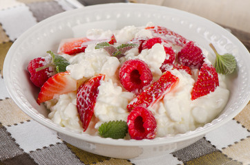 Fresh Cottage cheese with berries on  wooden table