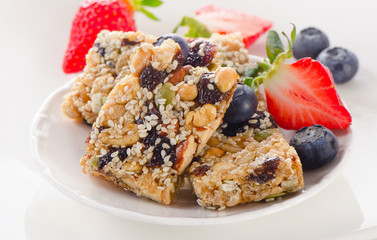 Healthy fruit and nut granola bars on white plate
