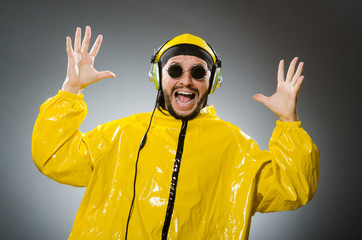 Man wearing yellow suit listening to headphones
