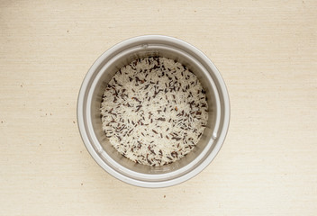 Mixed raw rice in cooking pot