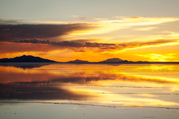 Sunset in the salar de uyuni, Bolivia. Reflection of the clouds in the wet salt surface