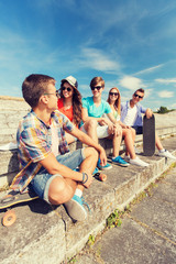 group of smiling friends sitting on city street