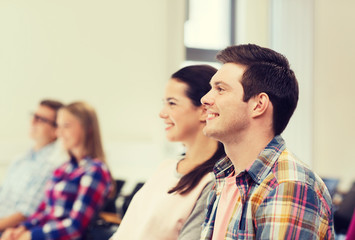 group of smiling students in lecture hall