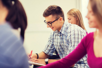 group of smiling students with notebook