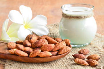 Almond milk in glass with almonds