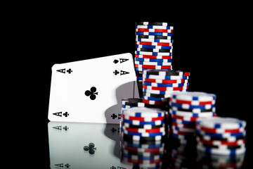 Poker chips and cards isolated on black background