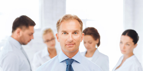businessman in office with group on the back