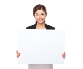 Fototapeta premium Young businesswoman showing the white banner