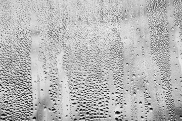 Rain drops created a natural pattern on window glass. Conversion to black and white, very detailed reflections - 86560026