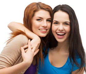 two laughing girls hugging