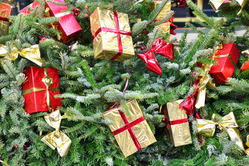 Christmas tree with gift boxes in shiny packages and winter rain drops - 86560286
