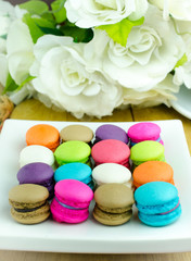 Colorful macarons on white plate/  Close up image