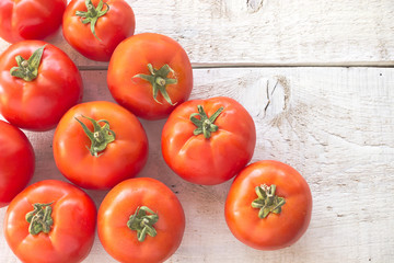 Tomatoes on white wooden surface