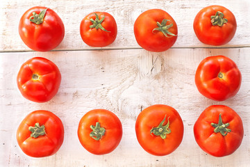 Tomatoes on white wooden surface