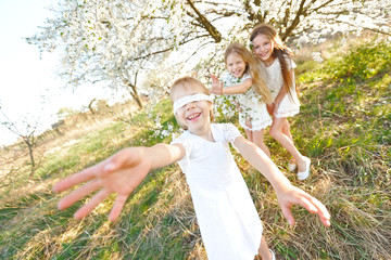 Portrait of little girls sisters in spring