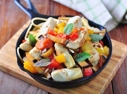 vegetarian pasta with artichokes, vegetables in tomato sauce
