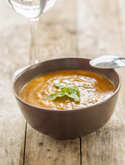  bowl of squash soup on wooden table