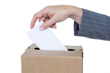 Businessman putting ballot in vote box