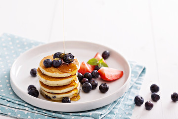 Stack of small pancakes with berries