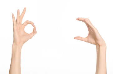 Hand gestures theme: the human hand shows gestures isolated on white background in studio