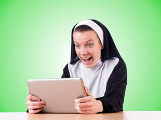 Nun working on laptop - religious concept