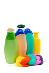 Bottles of shampoo, soap and colored sponge.