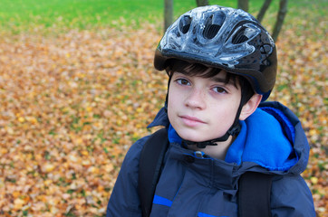 Boy with helmet. Kid with black bicycle helmet going to school.