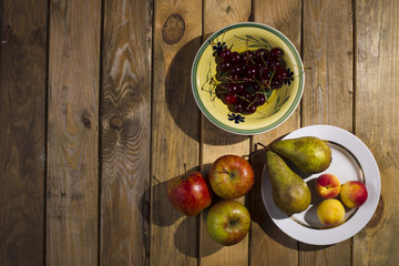 Fruits plates standing on a wooden background.