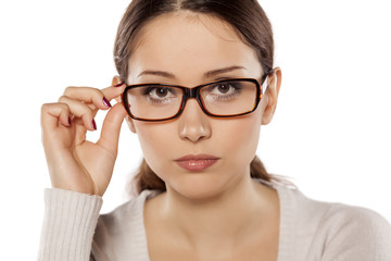 Beautiful serious woman posing with glasses