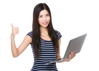 Woman use of the laptop computer and thumb up