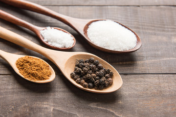 collection set of spices on wooden spoons. ( Black pepper, salt