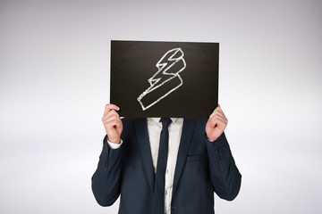 Composite image of businessman holding board