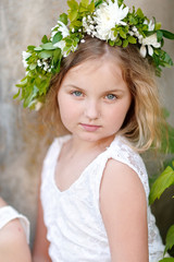 Fototapeta premium portrait of a beautiful little girl with flowers