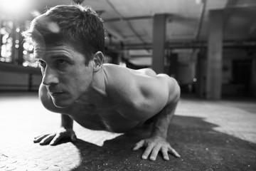 Black And White Shot Of Bare Chested Man Doing Press-Ups