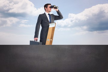 Composite image of businessman looking on a ladder © vectorfusionart