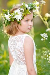 portrait of a beautiful little girl with flowers