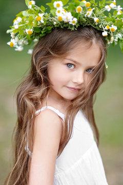 portrait of a beautiful little girl with flowers