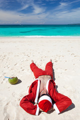 Santa Claus on beach relaxing