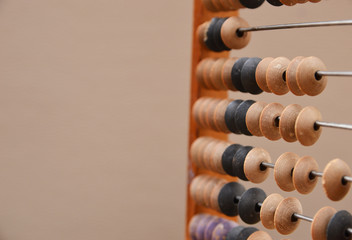 Old wooden abacus on gray background