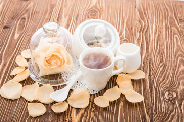Tea cups with teapot on old wooden table