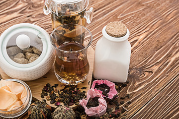 Tea cups with teapot on old wooden table