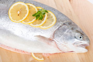 Full trout on wooden table