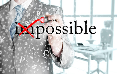 Businessman Hand turning the word Impossible into Possible with